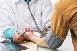 Photo of adult getting blood pressure checked